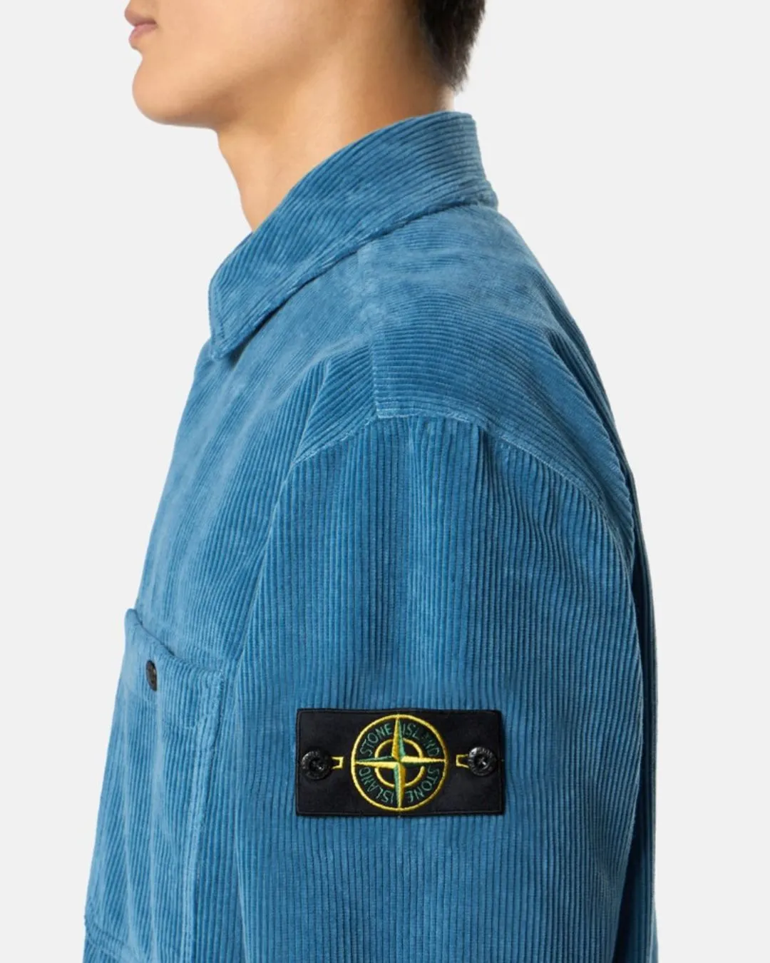 Stone Island badge worn on a blue cord overshirt